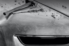 black and white image of the Boat Tail being created with hammers on top of the bonnet