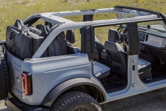 Every Bronco comes with class-exclusive frameless doors that make them easier to remove than what competitors offer. On four-door 2021 Bronco models, all doors can be stored onboard with protective door bags. Rear quarter windows are also removable, as shown on this four-door Bronco prototype. All have exclusive cowl-mounted mirrors to maintain sideview visibility when the doors are removed. (Prototype not representative of production vehicle.)